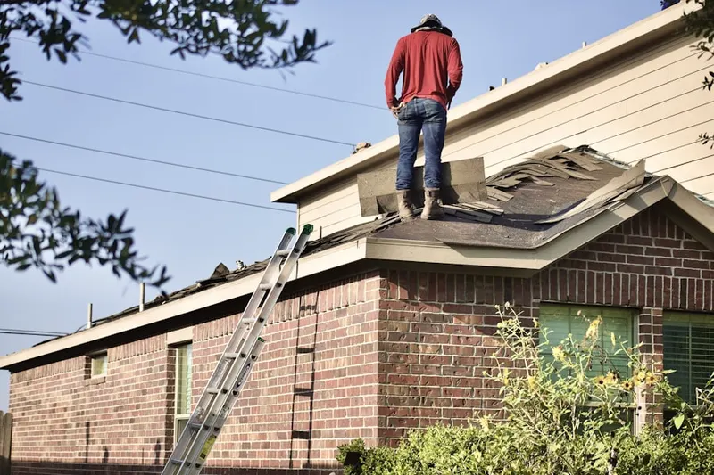 Professional roofer working on a residential roof in Ironspot